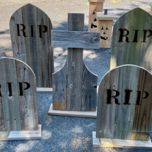 Cross tombstone and other wood tombstones with burned RIP letters