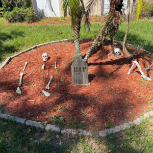 Small gothic point tombstone with skeleton ground breakers