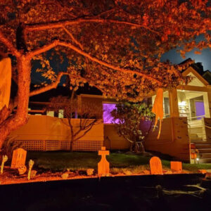 Tombstone Trio in yard with orange light