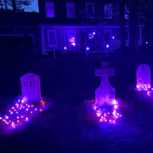 Tombstone Trio with purple string lights